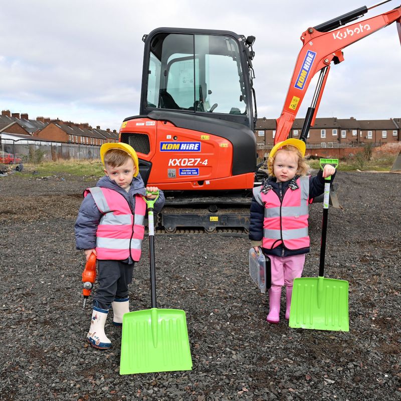Two small children standing on the site where the new Shankill Shared Women’s centre will be built
