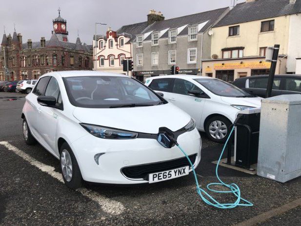 an electric car at an electric charging point